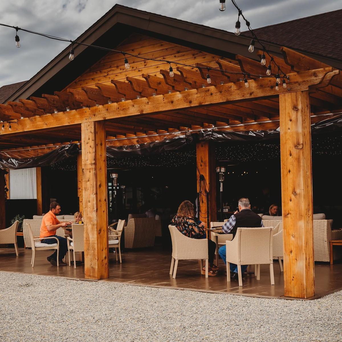 People relax on the covered outdoor patio at Doma