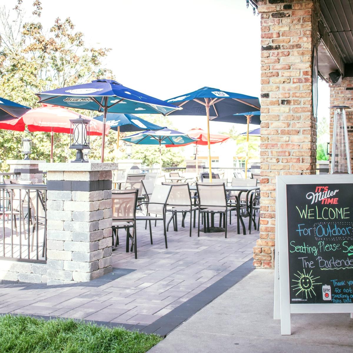 Picture of outdoor space with tables and chairs and umbrella for dining