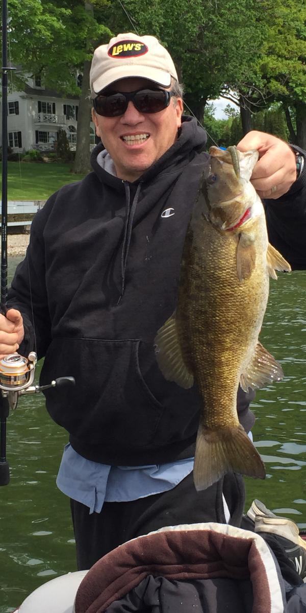 Big Catch in Cayuga with happy fisherman holding fish