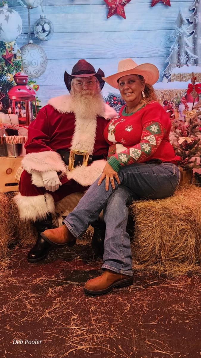 A woman poses with Santa in a cowboy hat at Texas Roadhouse in Palm Coast.