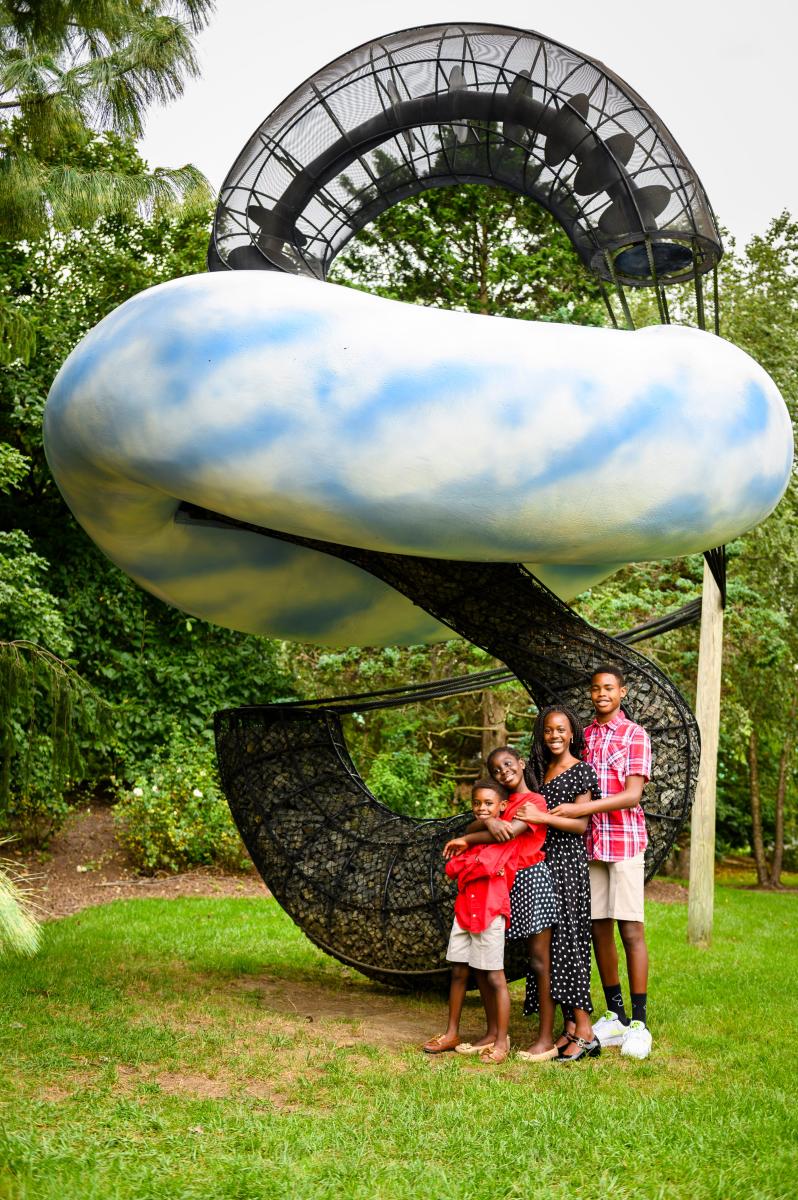 Kids posing in front of a sculpture at Grounds for Sculpture