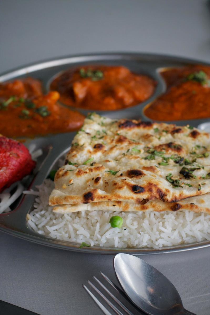 Image is of non, rice and different dipping options on a metal plate.