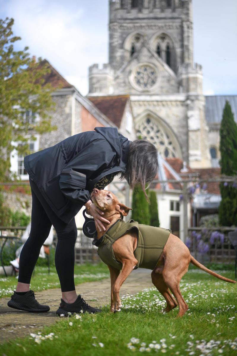 A person and dog outside Chichester Cathedral
