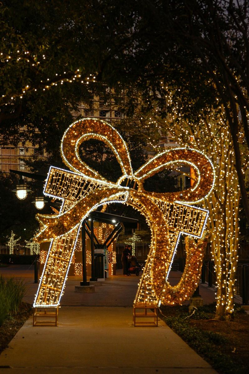 A display shaped like a giant gift box forms an arch along The Woodlands Waterway.