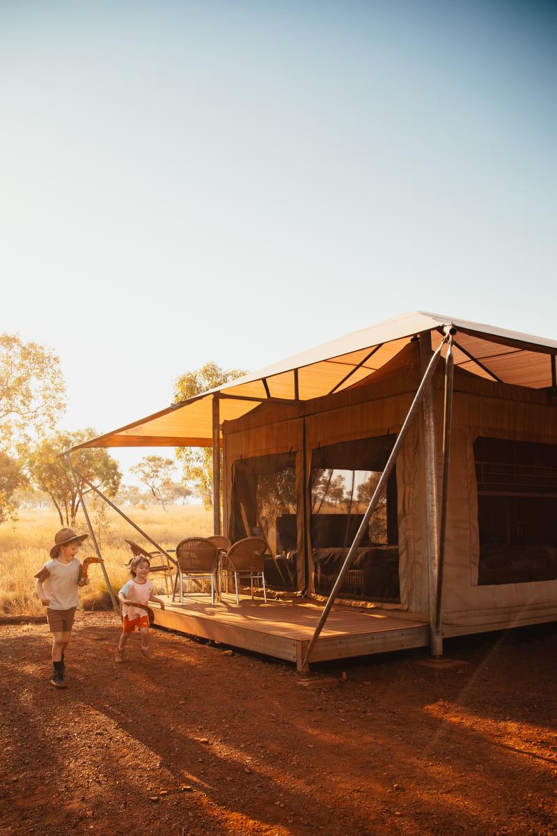 Children playing outside a family eco tent at Karijini Eco Retreat