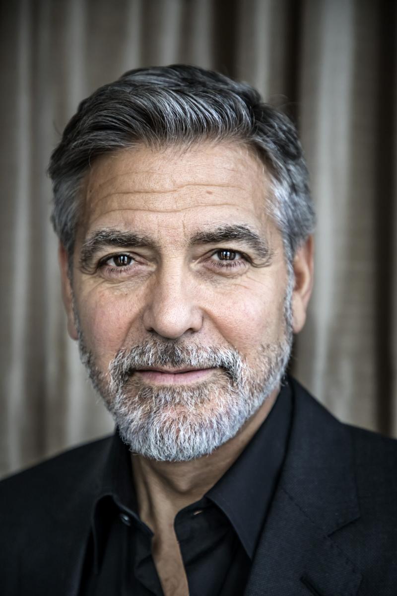 Image is of George Clooney head shot in a black shirt and black jacket.