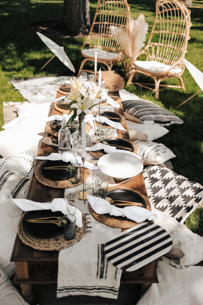 A black and white table spread on a low table outside