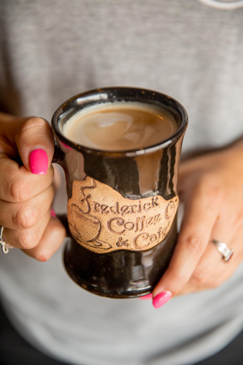 Woman Holding a cup from Frederick Coffee Company 14