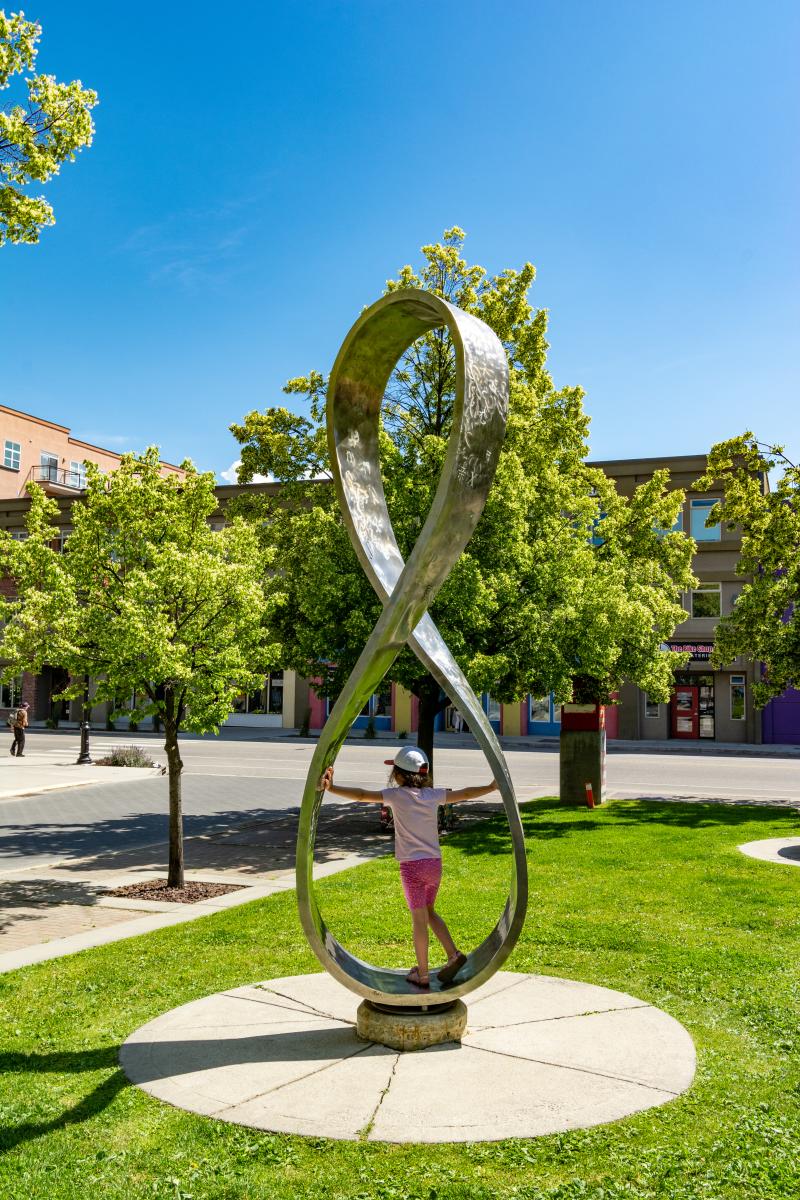 Child playing on public art at Kelowna Regional Library