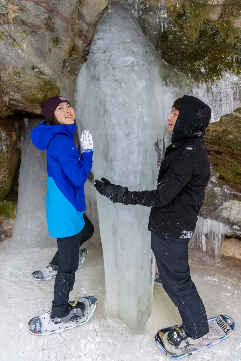 A large icicle is anchored to the ground at the falls.