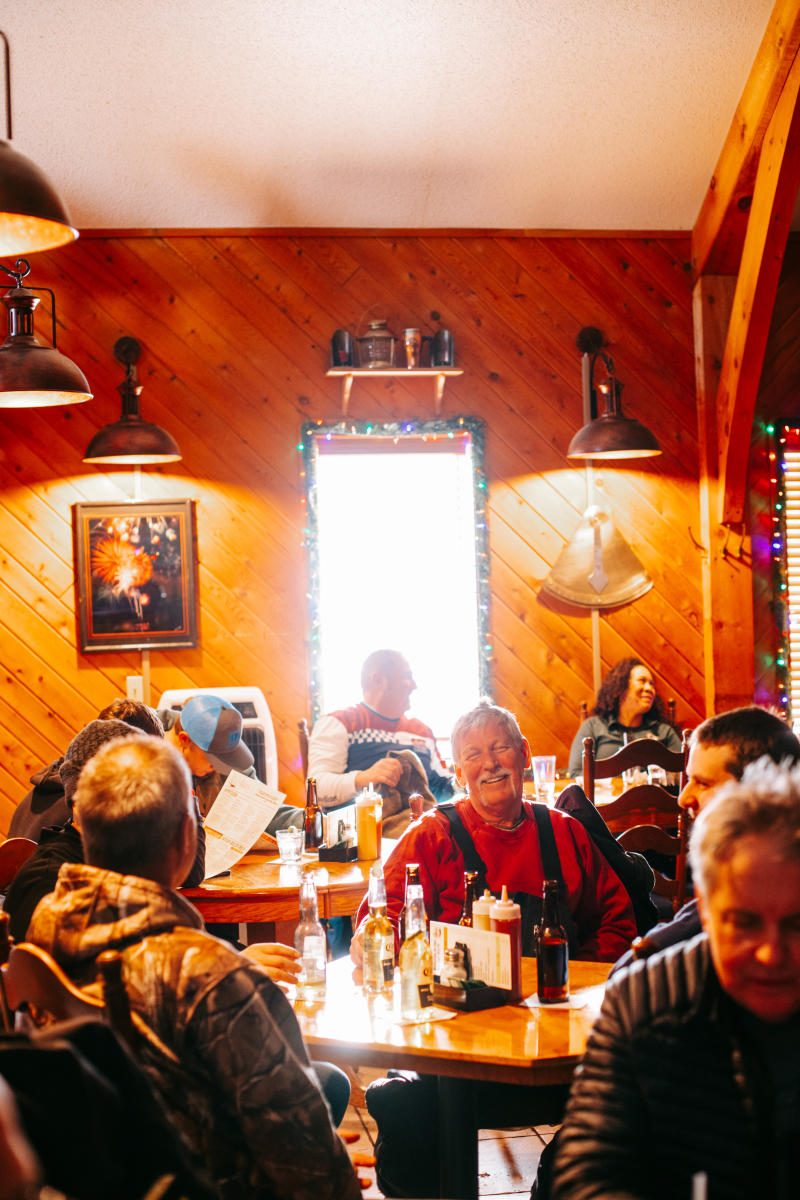 people fill a warm lodge-like restaurant