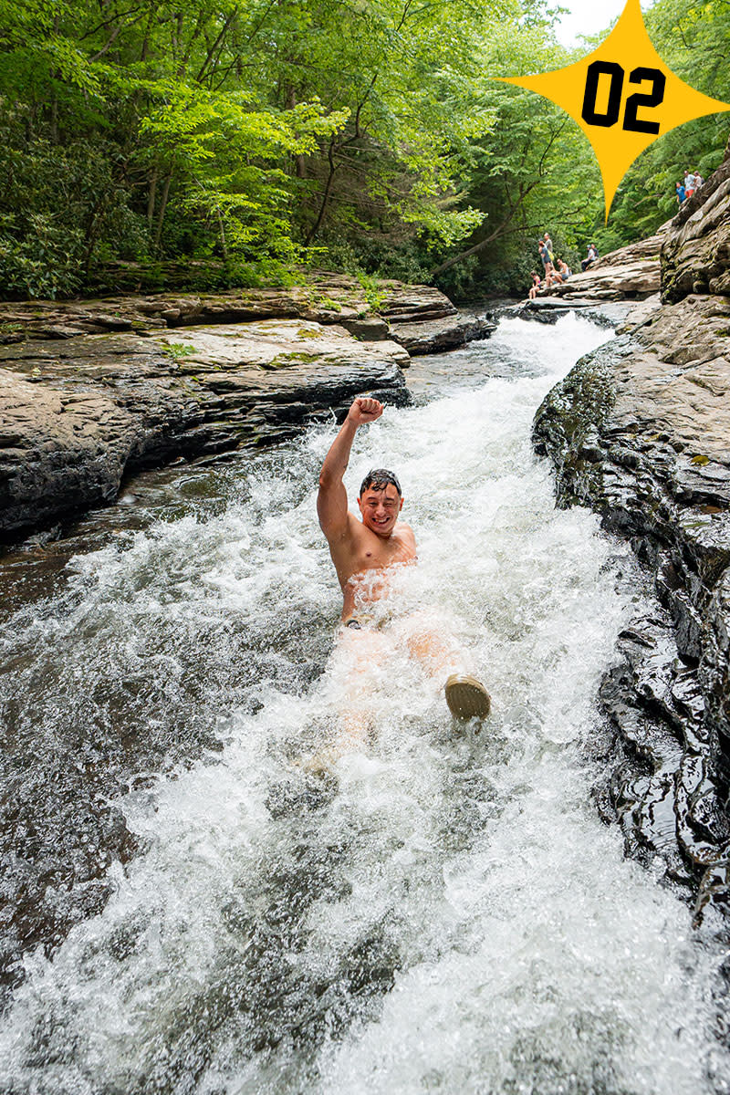 Man going down a natural waterslide at Ohiopyle