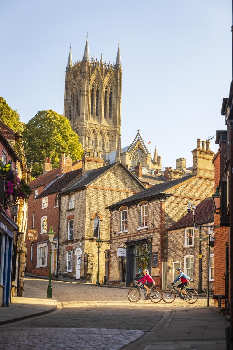 Image shows some cyclists on Lincoln's Steep Hill.