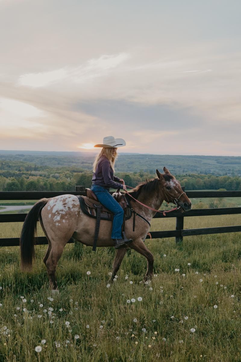 Woman Riding Horse at Nunda Ranch