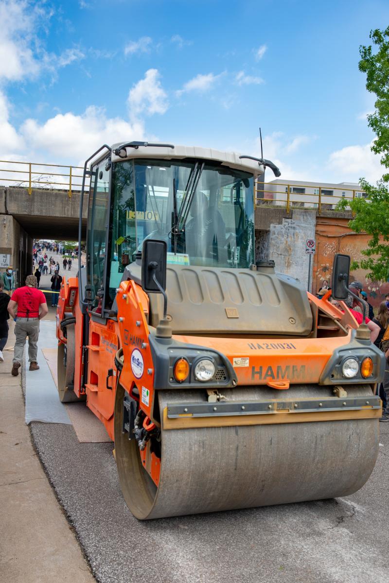 Dozens of giant wood block prints are inked and pressed by an actual steamroller during the Steamroller Festival