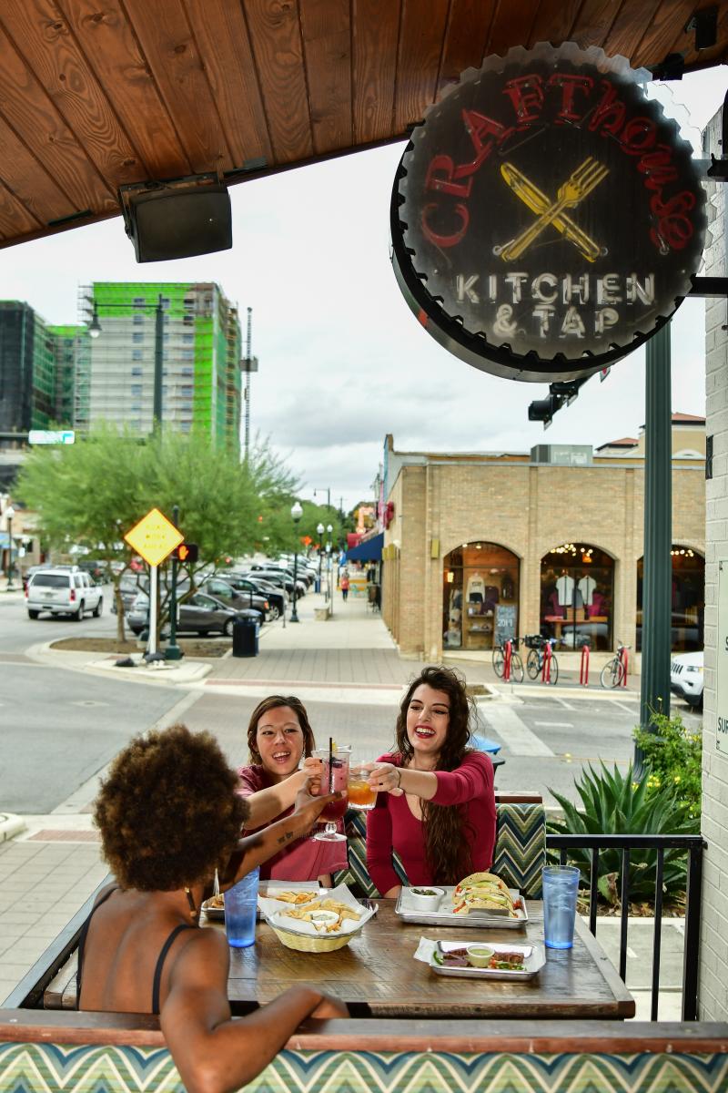 Group of women having lunch and cheers a drink