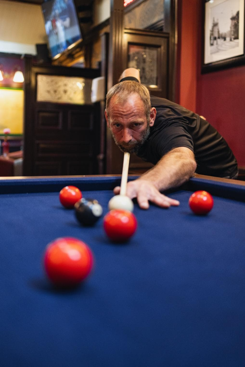 Middle aged man cueing up ball o