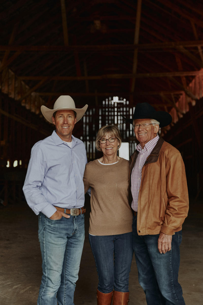 The Sinton Family standing in historic barn on the family ranch.