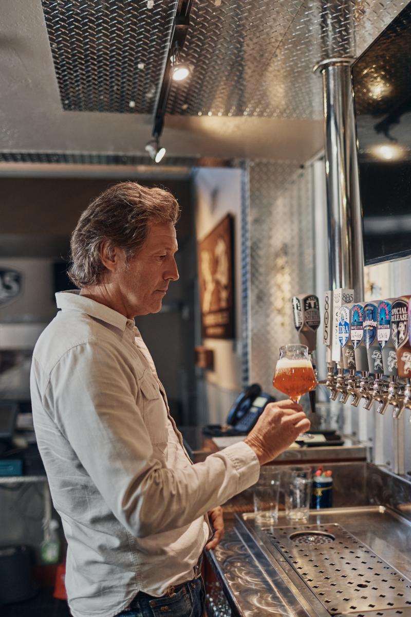 David Walker pours beer in taproom