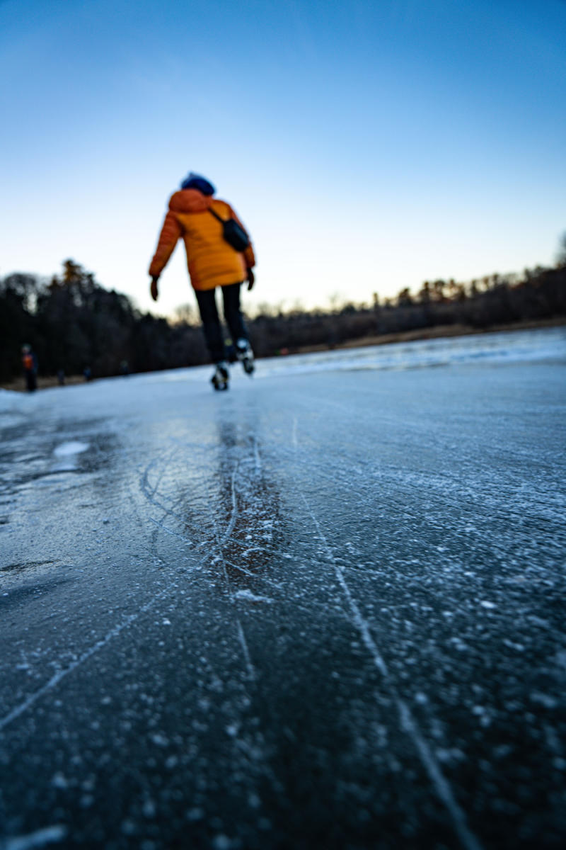 Skater glides across the ice on a winter day in Burlington, Vermont