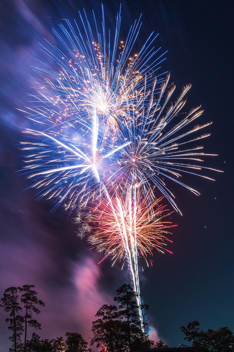 Red, White, and Blue fireworks explode over Town Green Park during the Red, Hot & Blue Festival on Independence Day.