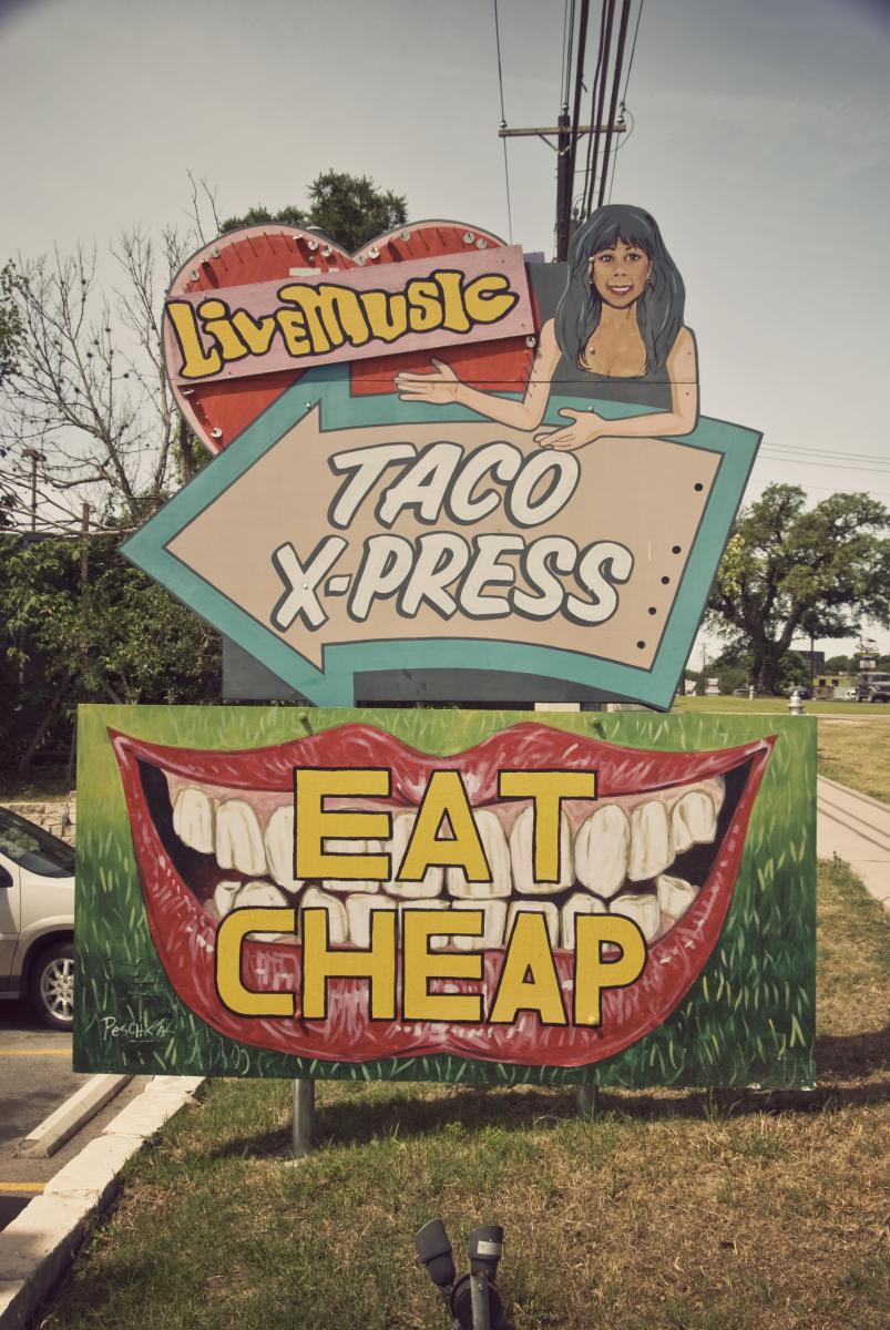 Sign at Marias with text saying live music taco xpress eat cheap