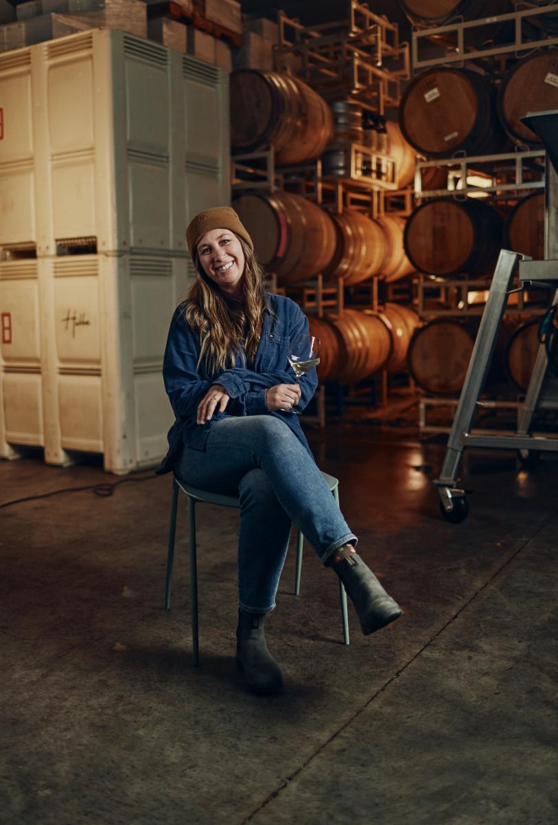 Riley Hubbard from Hubba Wines in Tin City, seated in her barrel room.