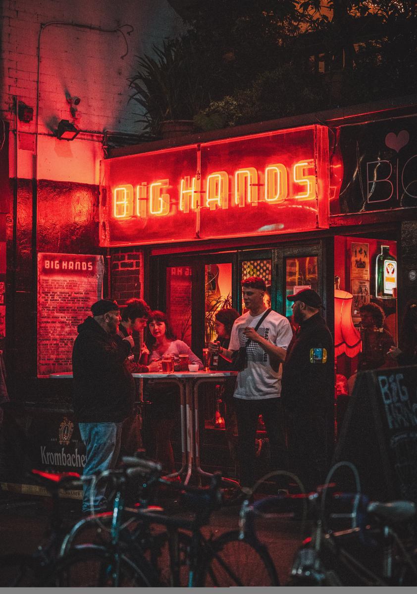 The outside of Big Hands bar in Manchester at night