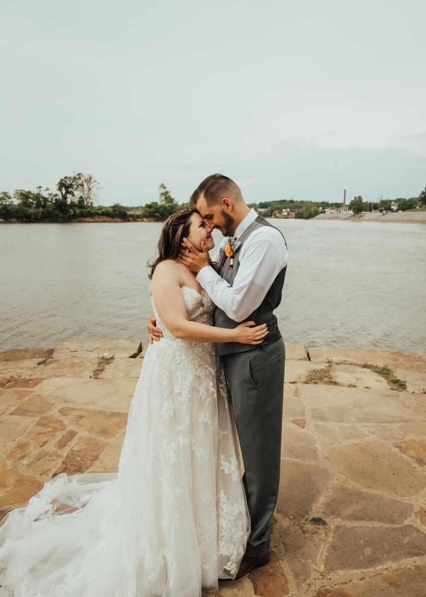 bridge and groom standing beside the river