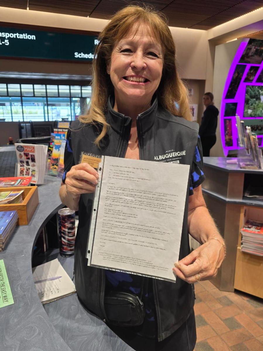 Visit Albuquerque volunteer Jolynn Maestas with her Volunteer of the Month certificate.