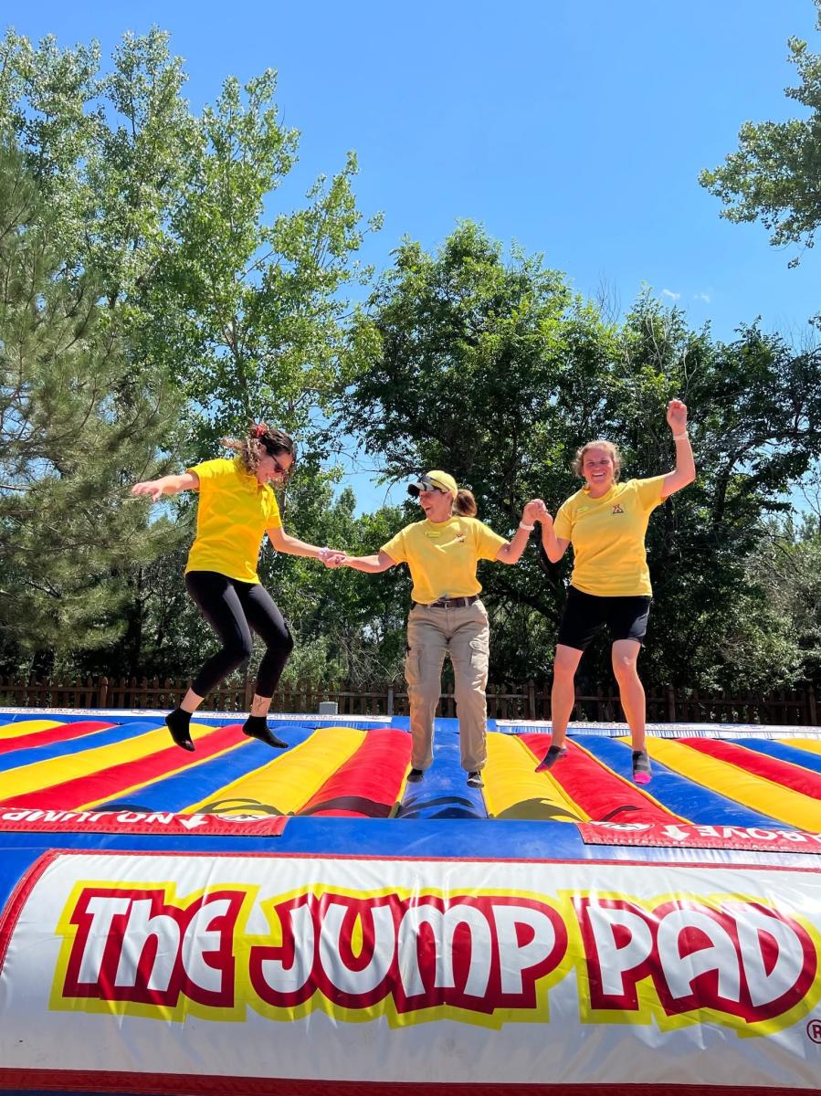 Three people jumping on a jump pad