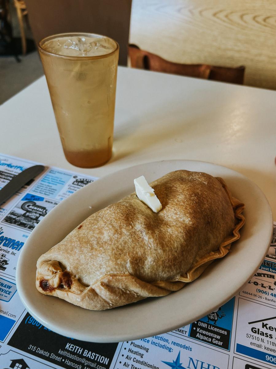 a plate sized pasty with a dab of butter on top