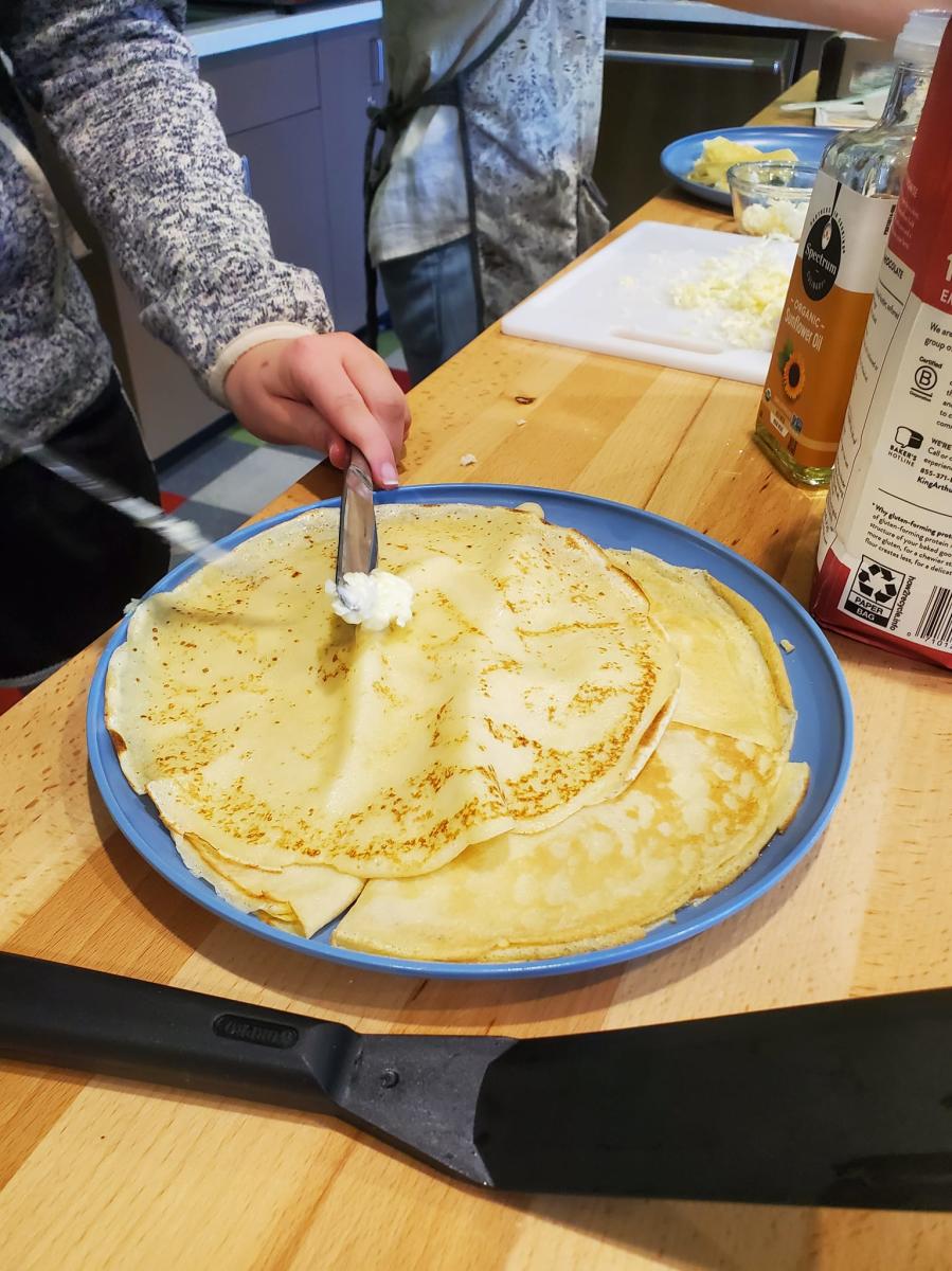Photo showing a stack of bliny, eastern European crepes, at a cooking class.
