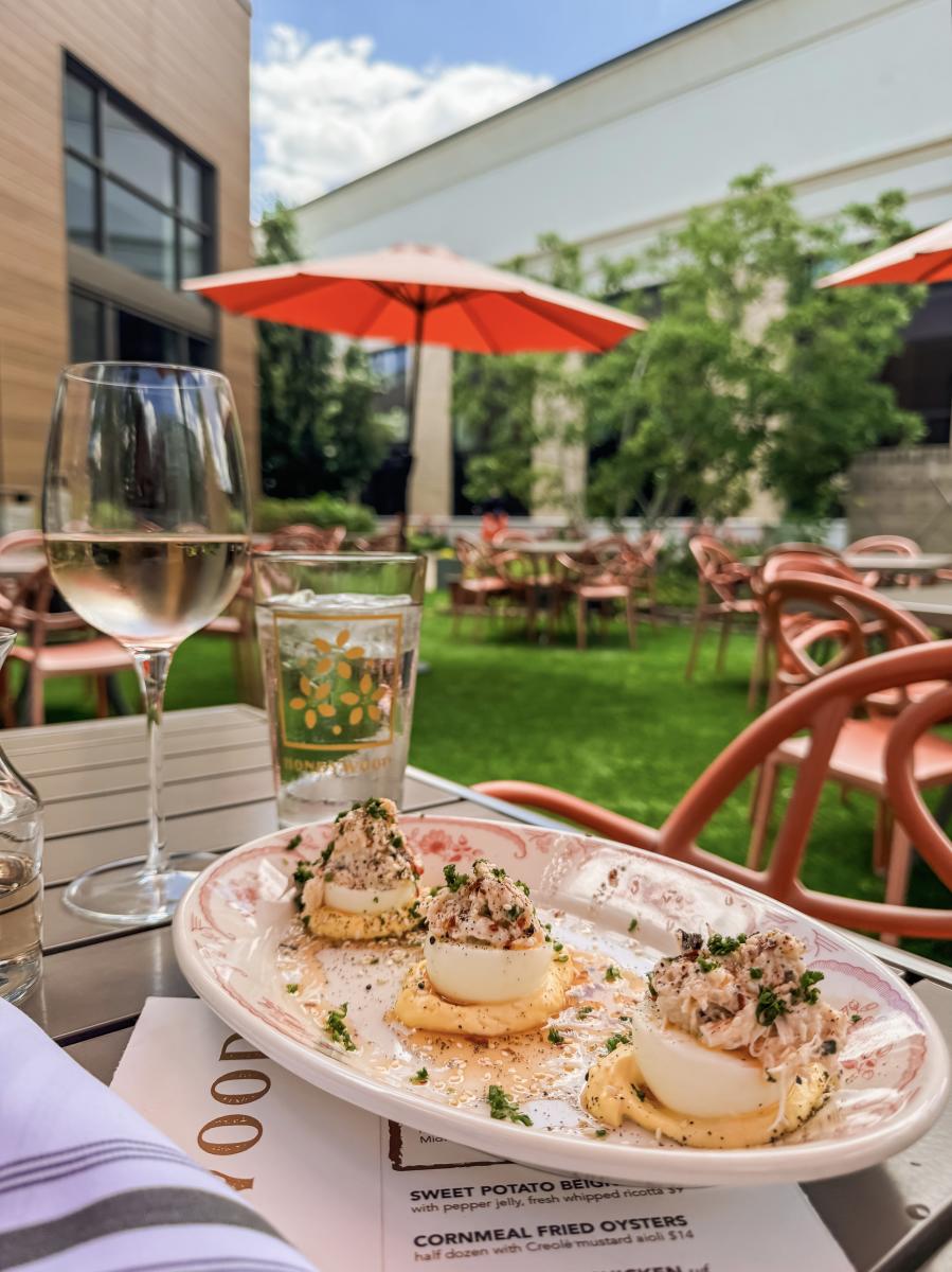 Happy hour with wine and deviled eggs on a patio