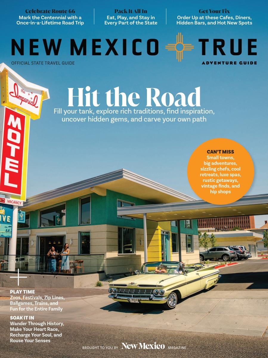 This is the cover of the "New Mexico True Adventure Guide." The image shows a vintage car parked in front of a retro-style motel, called the Imperial Motel. The sky is clear blue. Text on the cover highlights travel tips, including exploring Route 66, local attractions, and eateries.