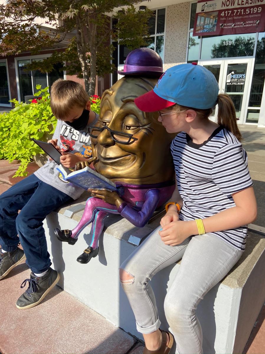 Kids reading by Sculpture Walk