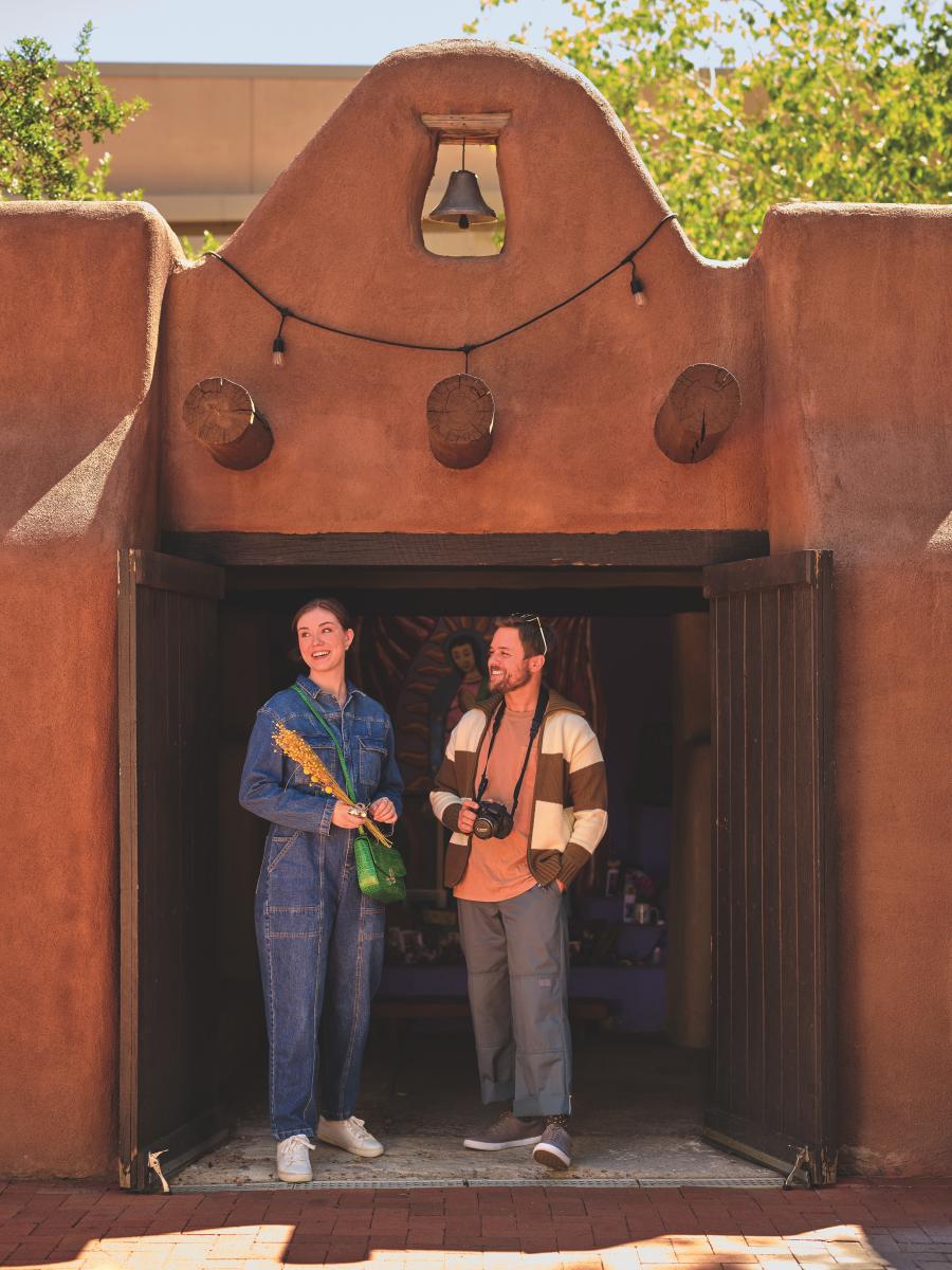 A couple stands in the doorway of a chapel in Old Town.