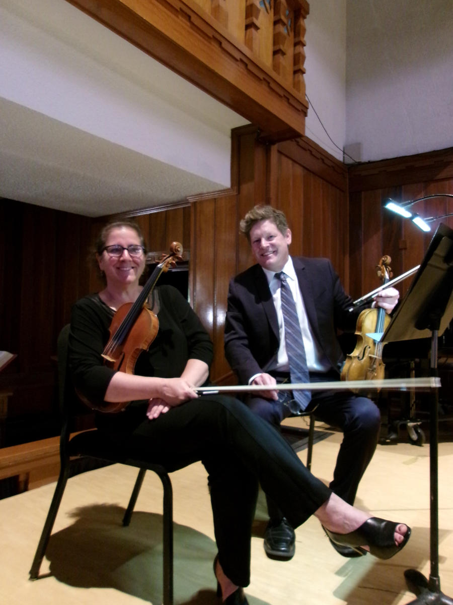 Two violinists pose during a New Mexico Philharmonic concert.