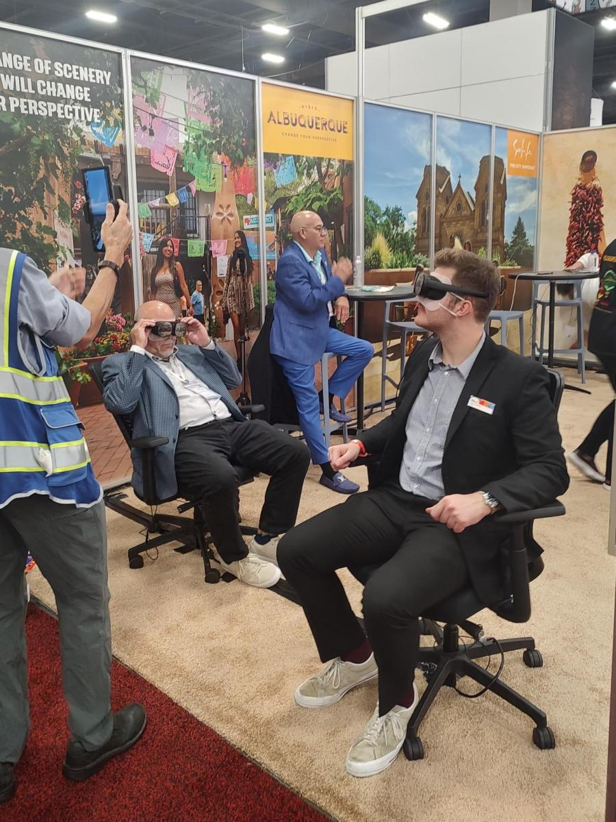 Visitors to the Visit Albuquerque booth at IMEX participate in a virtual reality hot air balloon ride