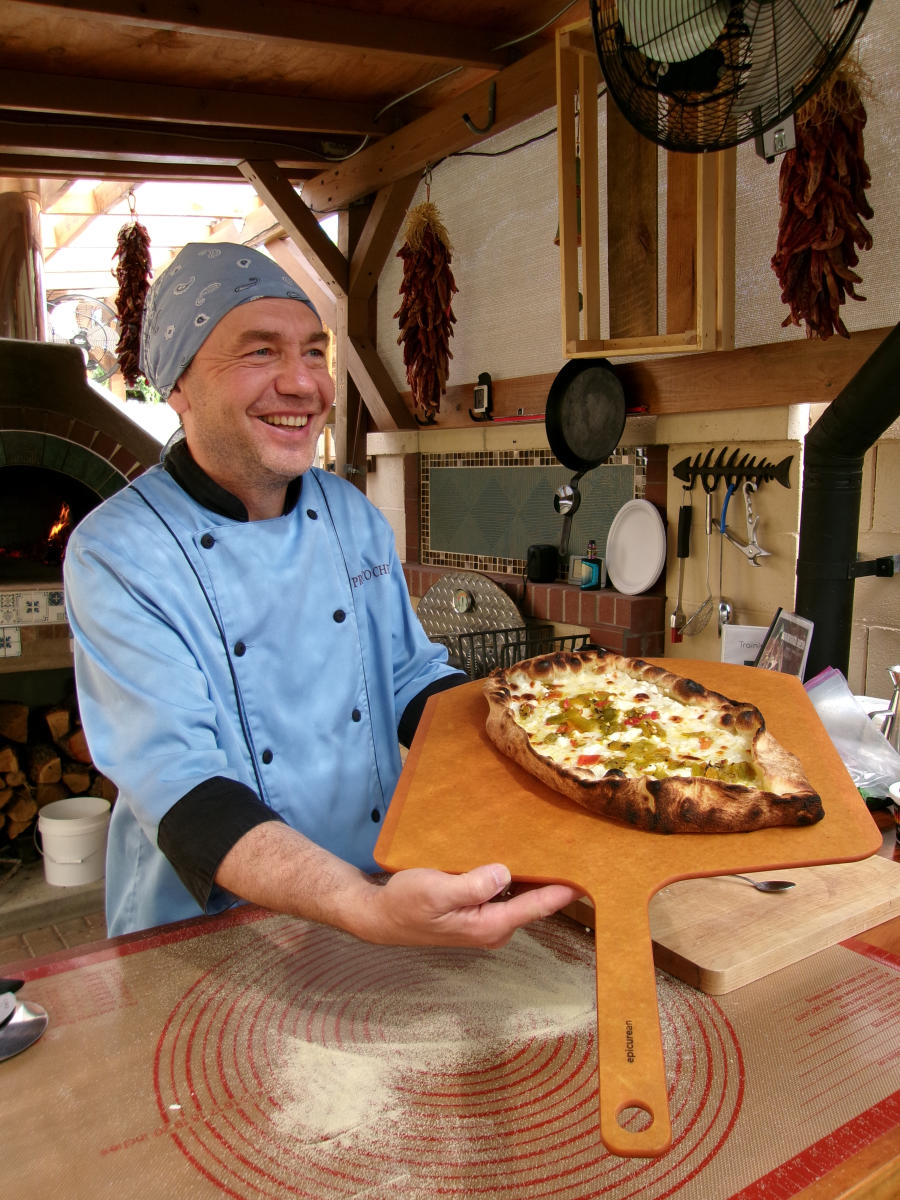 A picture of Igor holding a Turkish pizza.