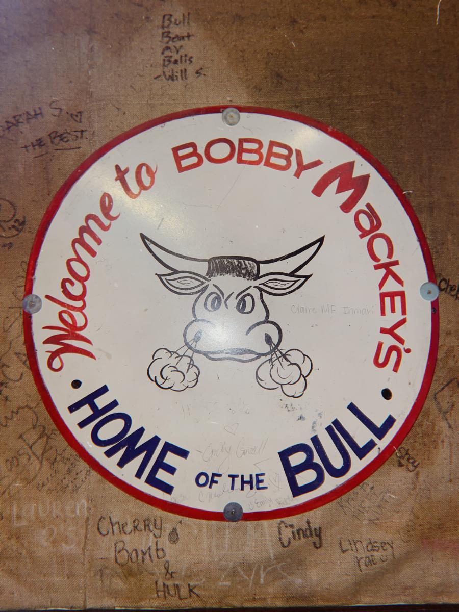 Image is of the sign inside Bobby Mackey's that say's "Welcome to Bobby Mackey's, Home of the Bull".