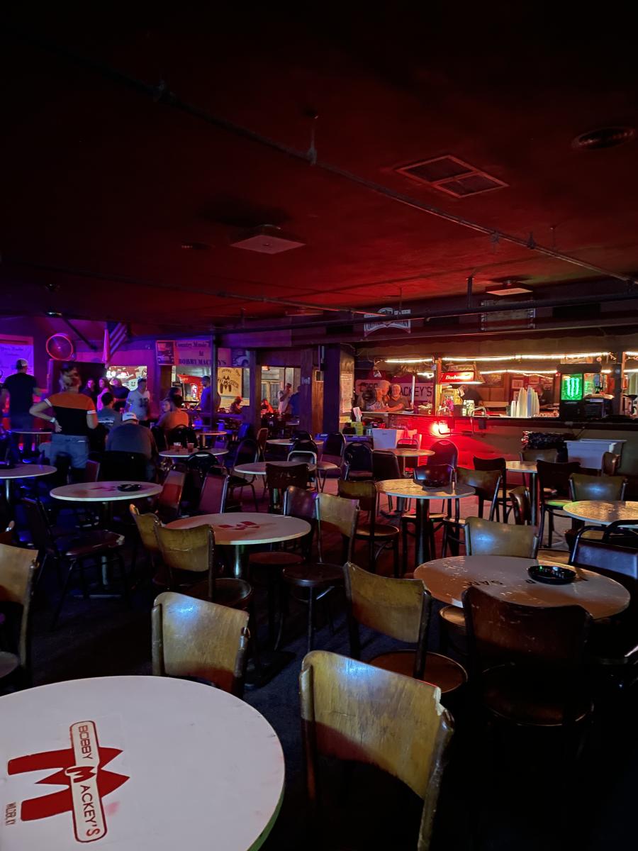 Image is of a bunch of tables and chairs inside Bobby Mackey's Bar.