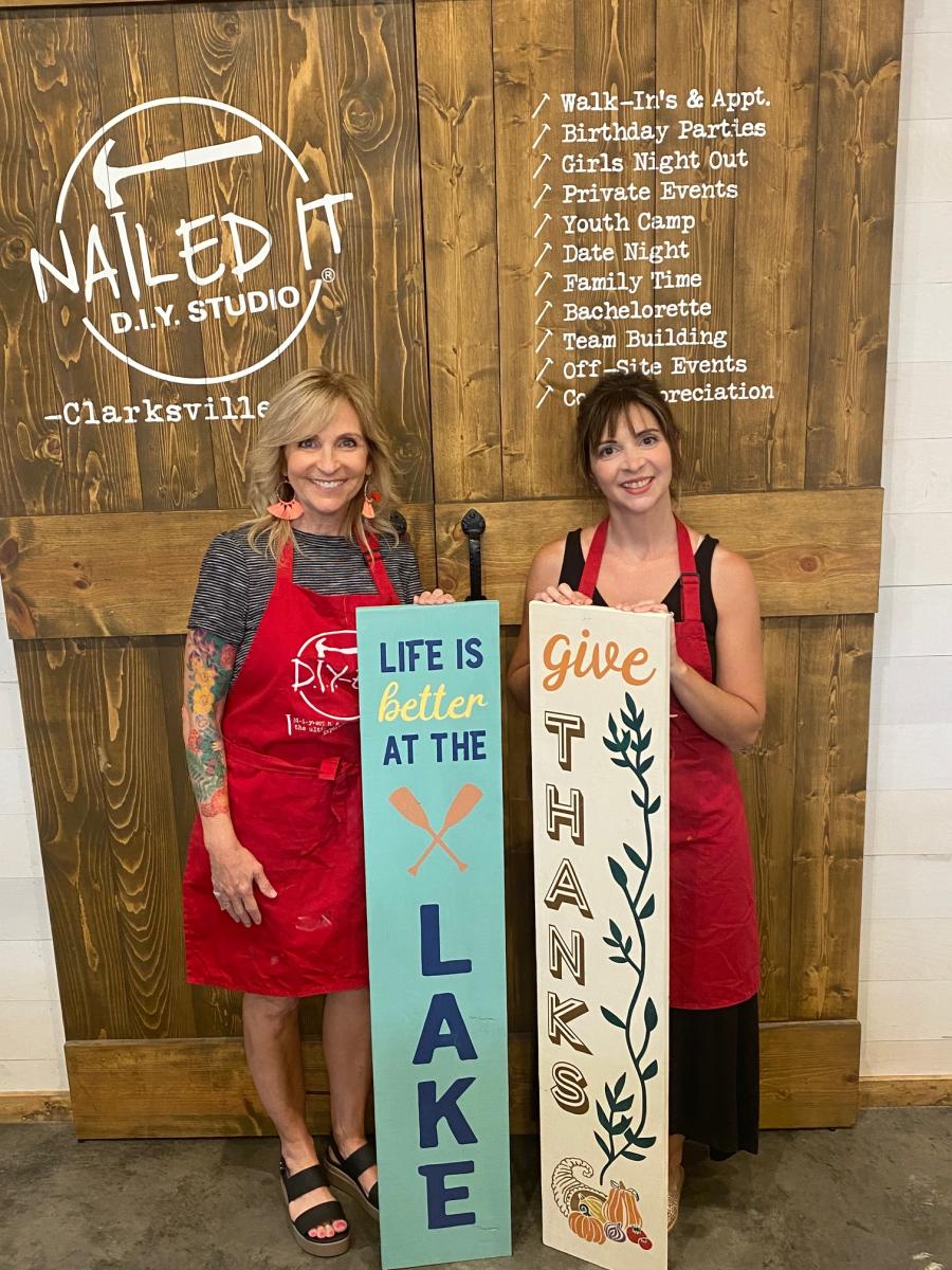 two ladies with painted signs