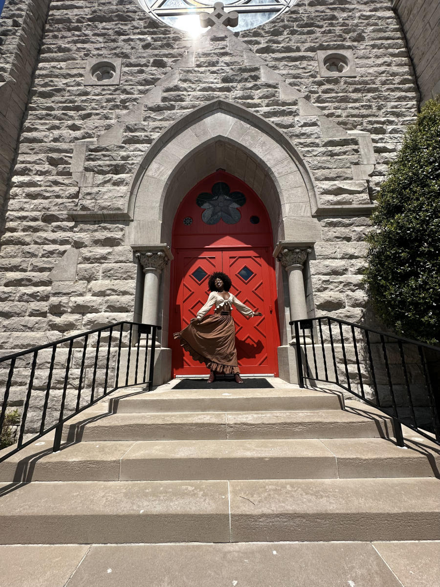 girl in front of a historic church