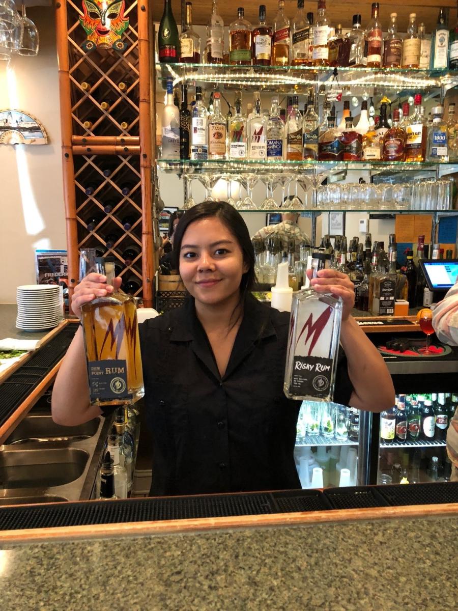 Sabor de Cuba! bartender holding bottles of rum