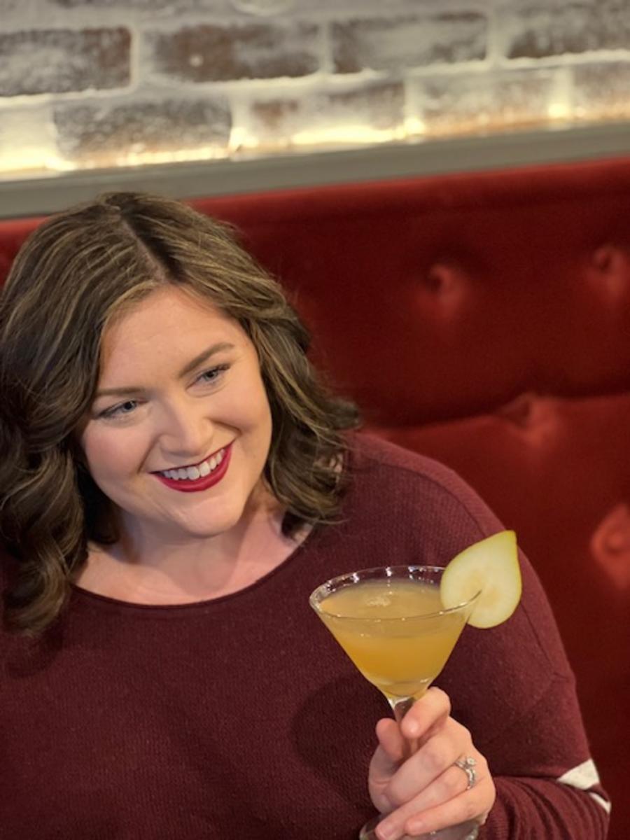 A Woman Drinking A Cocktail From Purveyor 