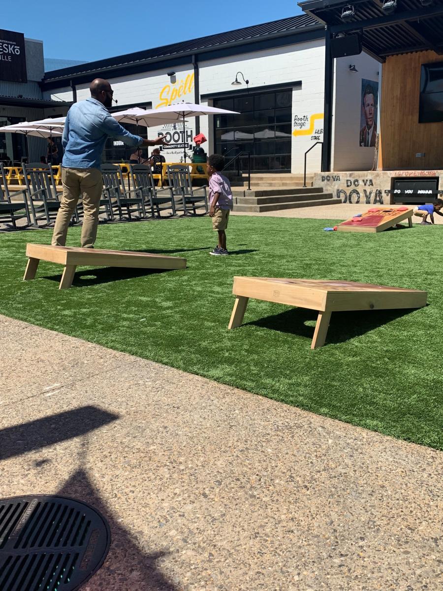 Family Playing Cornhole At Zenovia Stovehouse