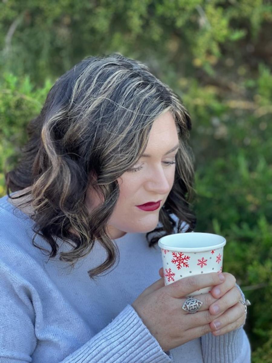 A woman drinking a holiday beverage