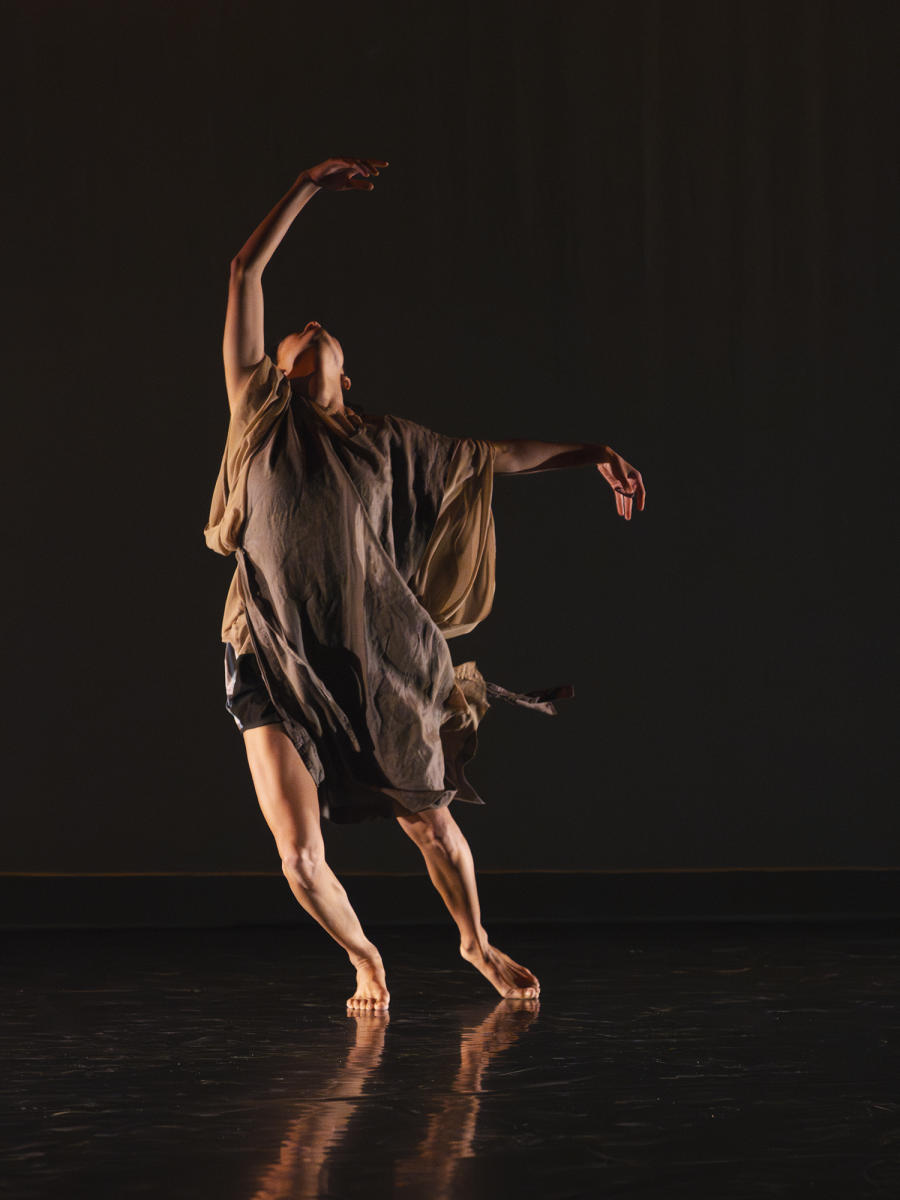 A dancer in brown, flowing cloth moves on stage during RADFest.