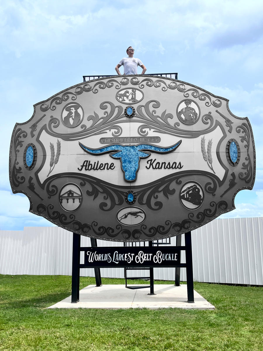 Man poses with largest belt buckle